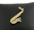 Złota broszka saksofon