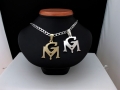 Zawieszki złota i srebrna -symbol GM